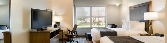 Standard Double Queen Room with desk, tv and lounge chair